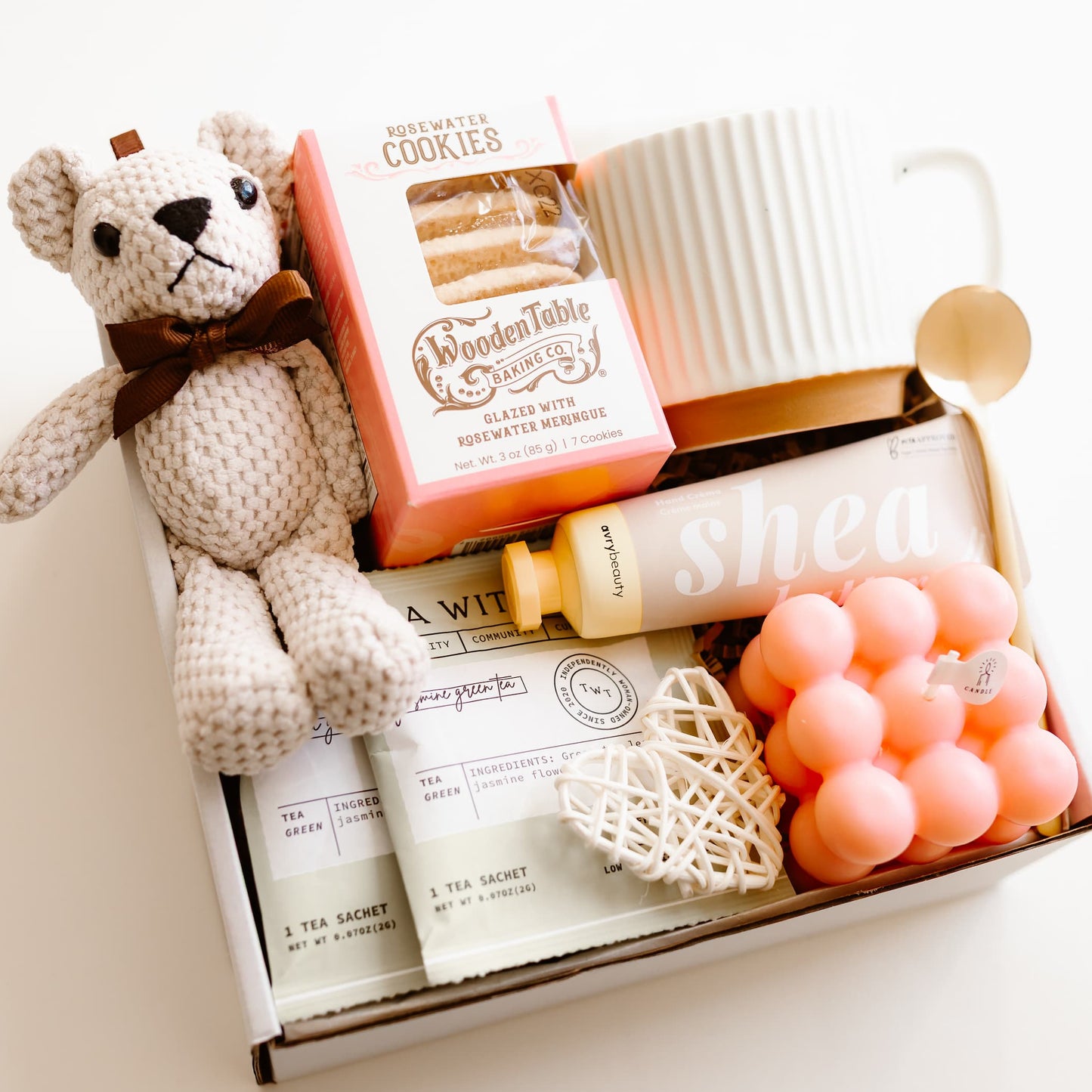 Valentine’s gift box with rosewater cookies, ceramic mug, gold spoon, tea sachets, teddy bear, bubble candle, shea hand cream, and decorative heart