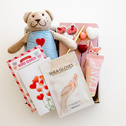 Valentine’s self-care gift box with teddy bear, rose hand lotion, hand mask gloves, notebook with gold pen, word game, and personalized love-themed card