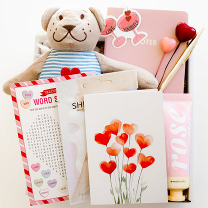 Valentine’s self-care gift box with teddy bear, rose hand lotion, hand mask gloves, notebook with gold pen, word game, and personalized love-themed card