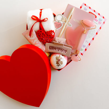 Valentine’s self-care heart-shaped gift box with rosewater hand lotion, facial roller and gua sha set, bath bomb, socks, notebook, and personalized greeting card