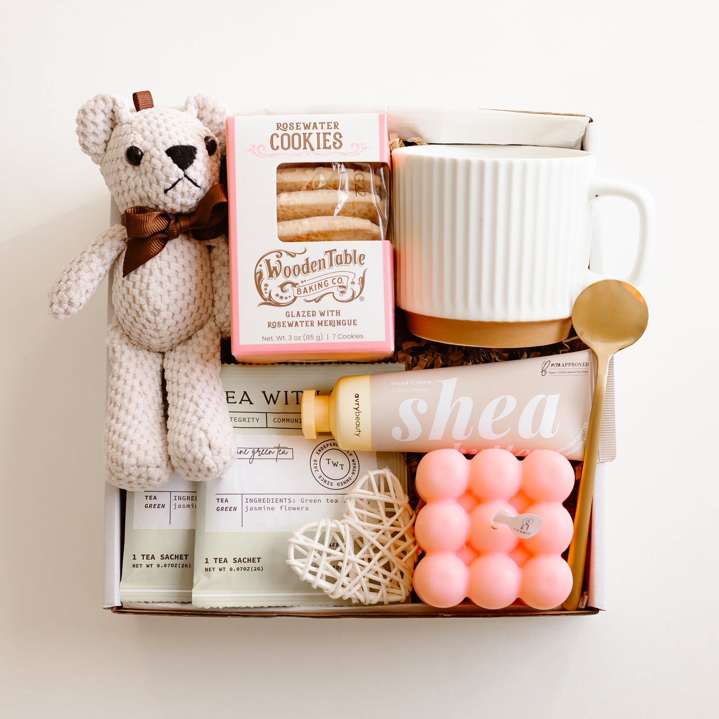 Valentine’s gift box with rosewater cookies, ceramic mug, gold spoon, tea sachets, teddy bear, bubble candle, shea hand cream, and decorative heart