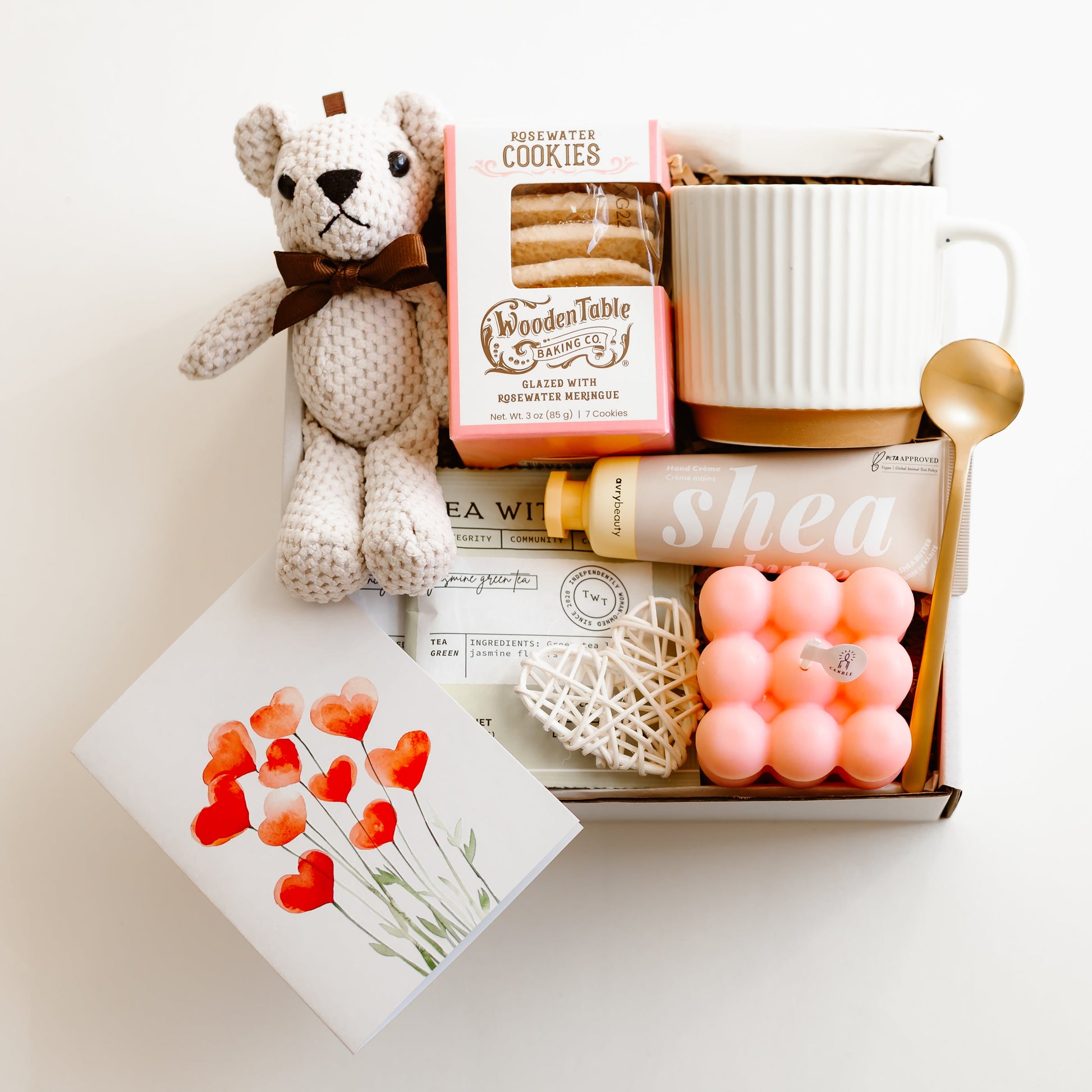 Valentine’s gift box with rosewater cookies, ceramic mug, gold spoon, tea sachets, teddy bear, bubble candle, shea hand cream, and decorative heart