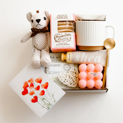 Valentine’s gift box with rosewater cookies, ceramic mug, gold spoon, tea sachets, teddy bear, bubble candle, shea hand cream, and decorative heart