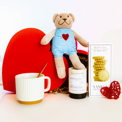 Valentine’s Day heart-shaped gift box with vanilla cookies, oolong tea sachets, ceramic mug, gold spoon, and teddy bear